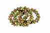 A coil of round beads with green and red speckled patterns on a white surface.
